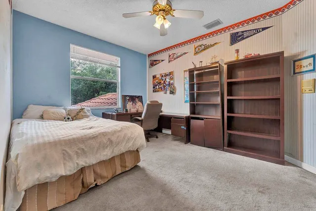 a bedroom with a large bed and a chandelier