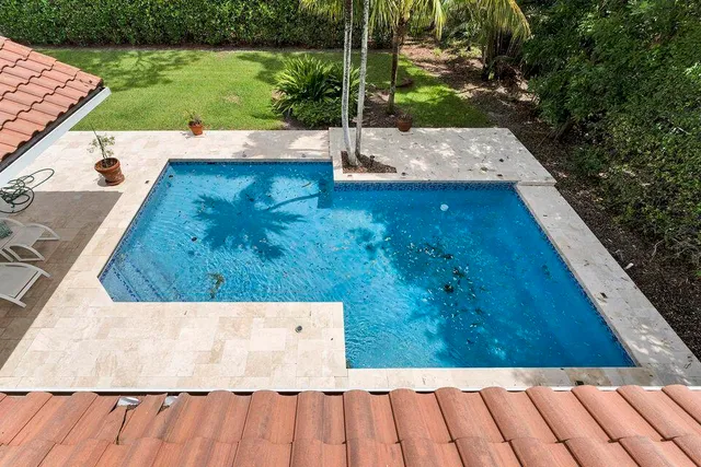 a view of swimming pool with chairs