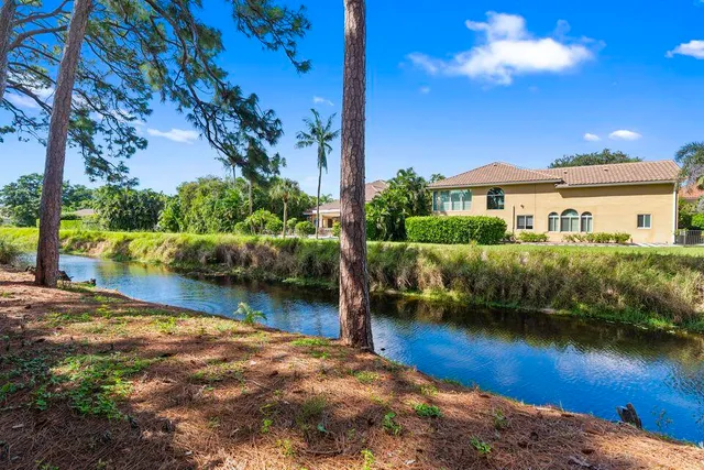 a view of a house with a yard and sitting area