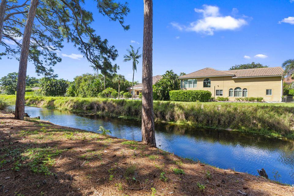 3271 Harrington Drive Boca Raton, FL 33496 - Photo 4 of 43 a view of a house with a yard and sitting area
