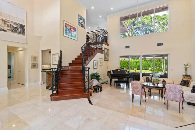 a living room with furniture and a chandelier