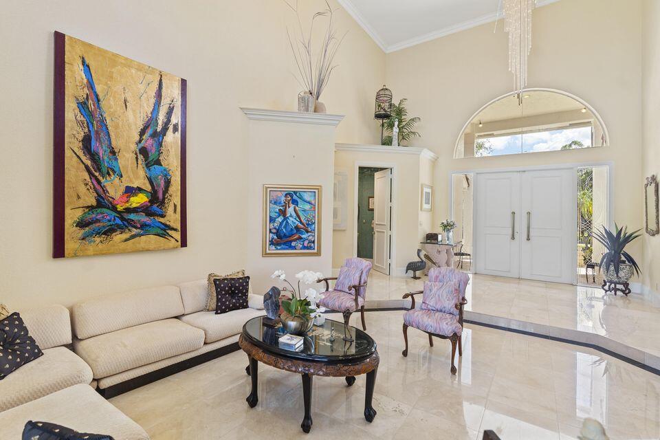 3271 Harrington Drive Boca Raton, FL 33496 - Photo 6 of 43 a living room with furniture and a chandelier