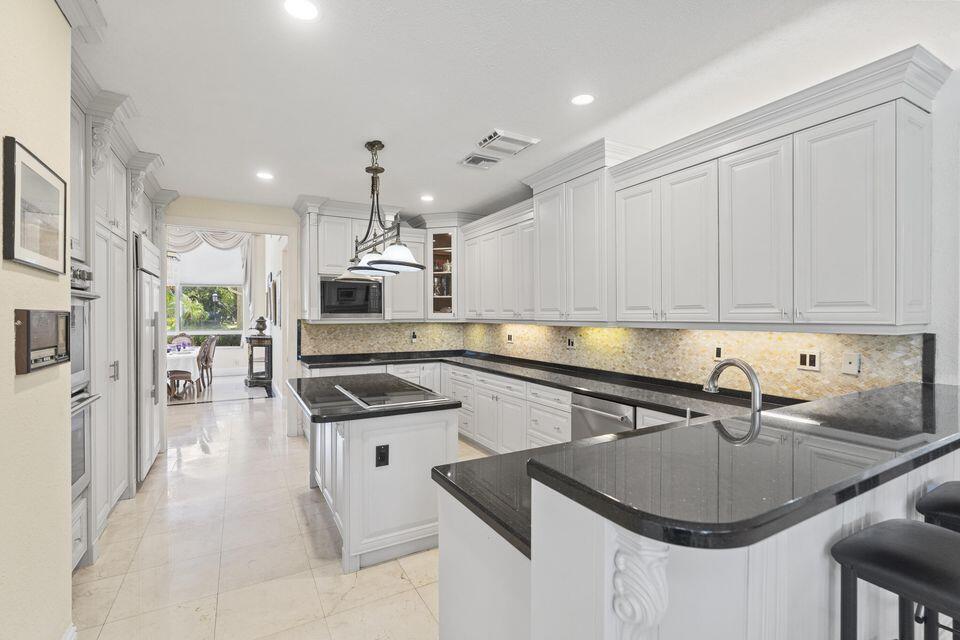 3271 Harrington Drive Boca Raton, FL 33496 - Photo 8 of 43 a kitchen with stainless steel appliances granite countertop a sink a stove and a refrigerator