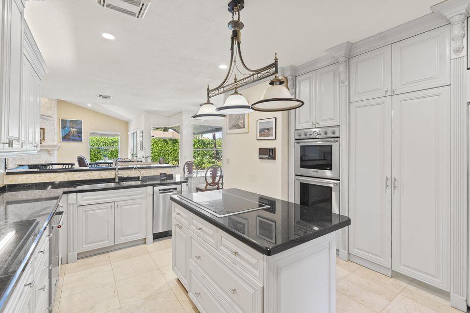 3271 Harrington Drive Boca Raton, FL 33496 - Photo 9 of 43 a kitchen with stainless steel appliances granite countertop a sink a stove and refrigerator