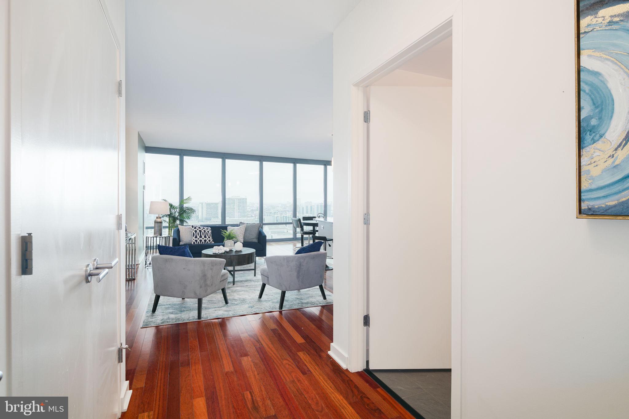 2101 Market Street, Unit 1901 Philadelphia, PA 19103 - Photo 2 of 25 a living room with furniture and a wooden floor