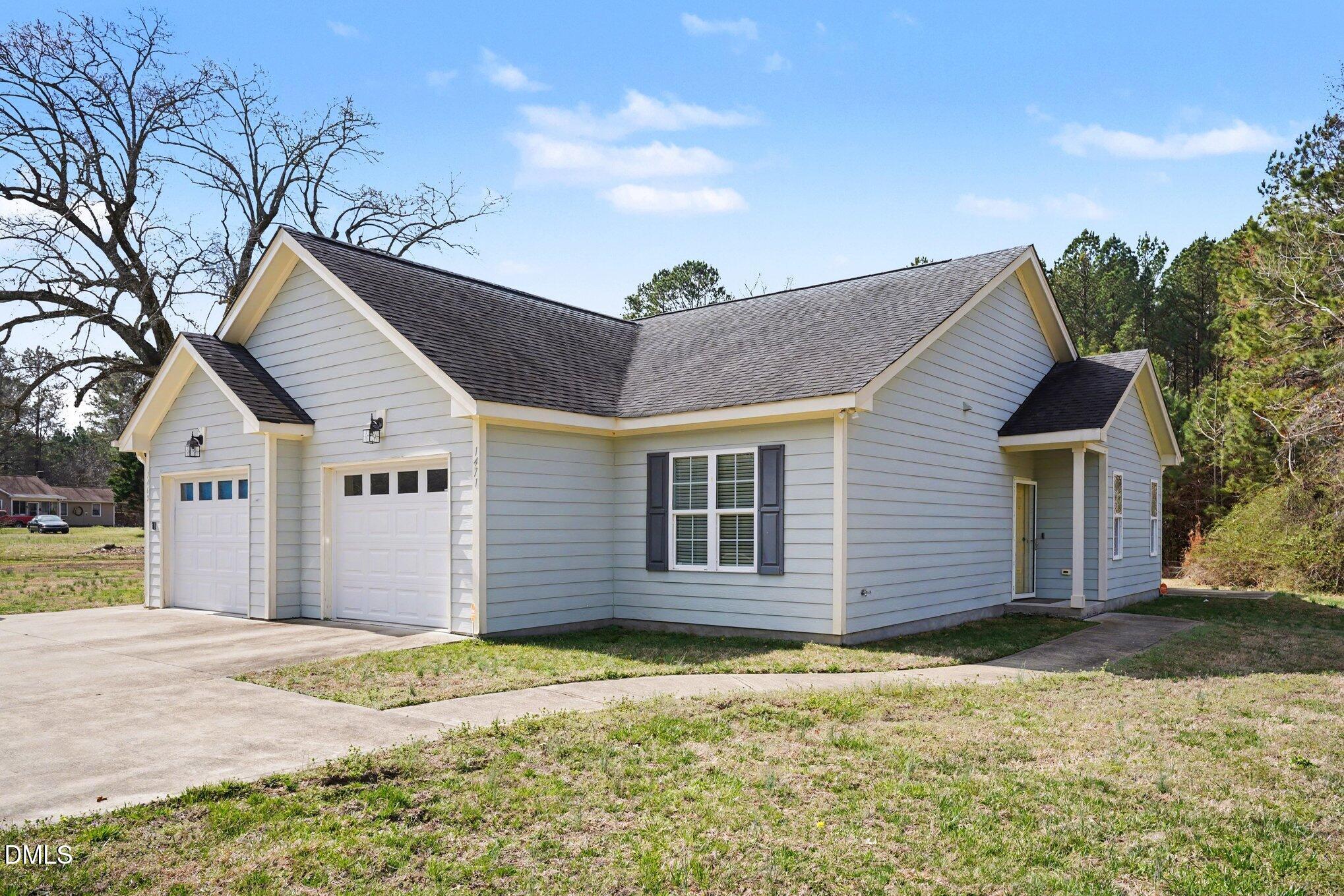 1471 Thanksgiving Fire Road Selma, NC 27576 - Photo 1 of 16 a view of a house with a yard