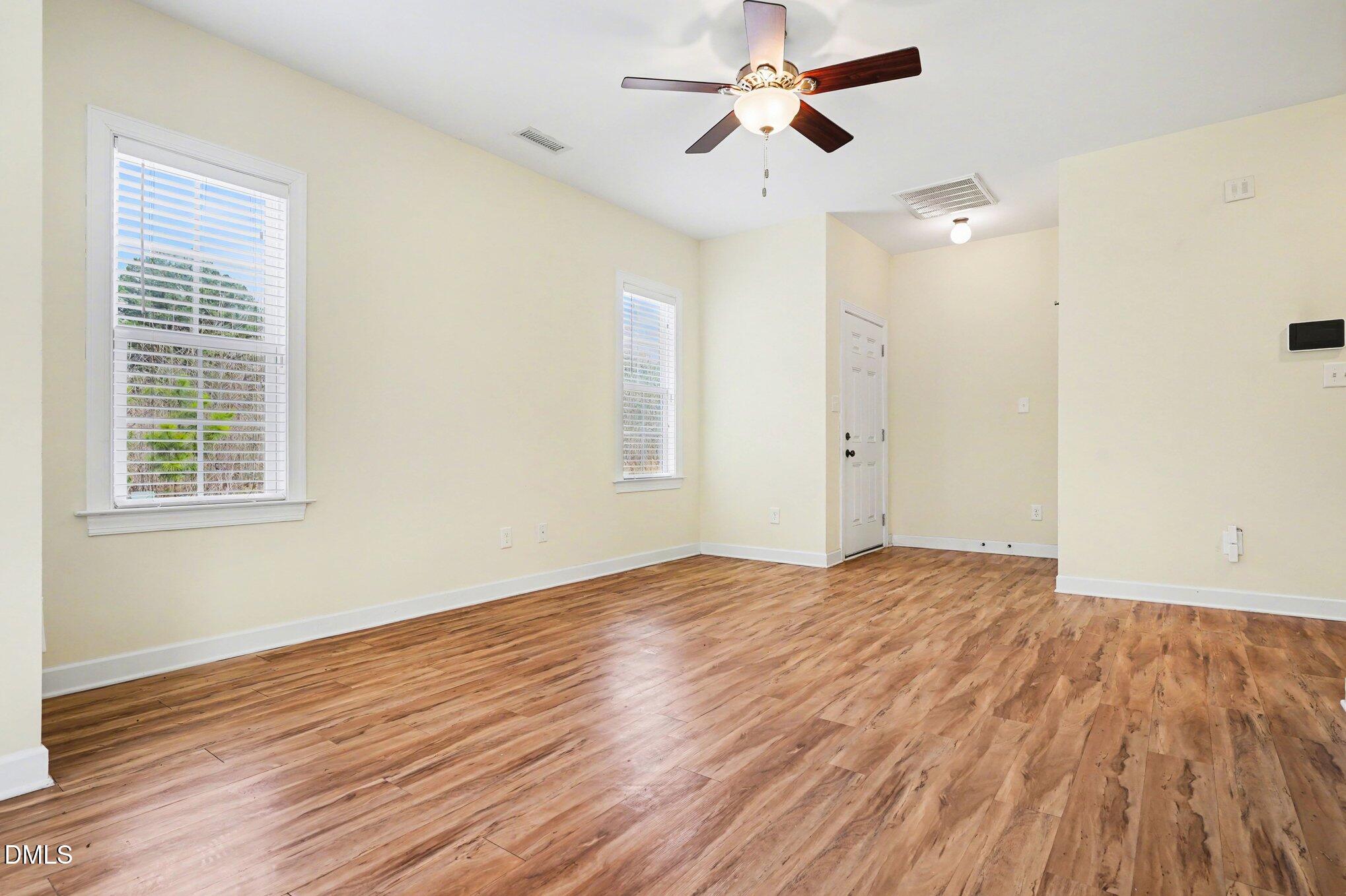1471 Thanksgiving Fire Road Selma, NC 27576 - Photo 3 of 16 a view of empty room with wooden floor and fan