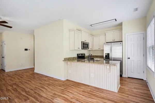 a kitchen with a refrigerator and a sink