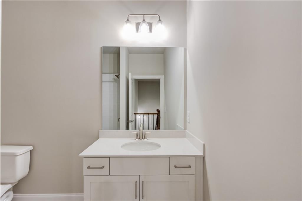 5630 Overlook Club Circle Suwanee, GA 30024 - Photo 23 of 32 a bathroom with a sink and a mirror