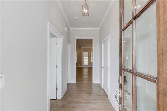 a view of a hallway with wooden floor and staircase