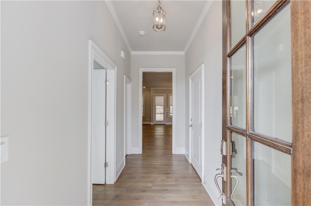 5630 Overlook Club Circle Suwanee, GA 30024 - Photo 4 of 32 a view of a hallway with wooden floor and staircase