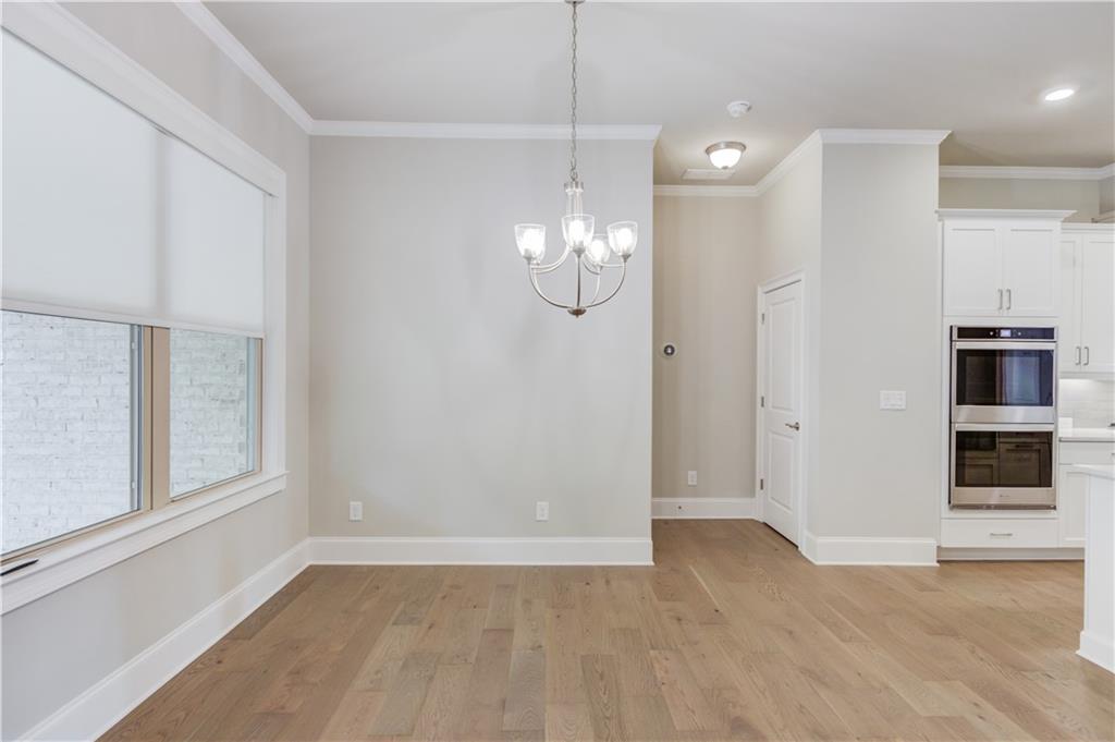 5630 Overlook Club Circle Suwanee, GA 30024 - Photo 6 of 32 wooden floor in an empty room with a window
