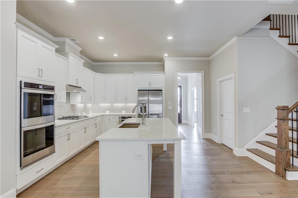 5630 Overlook Club Circle Suwanee, GA 30024 - Photo 9 of 32 a kitchen with stainless steel appliances granite countertop a refrigerator a stove and a sink