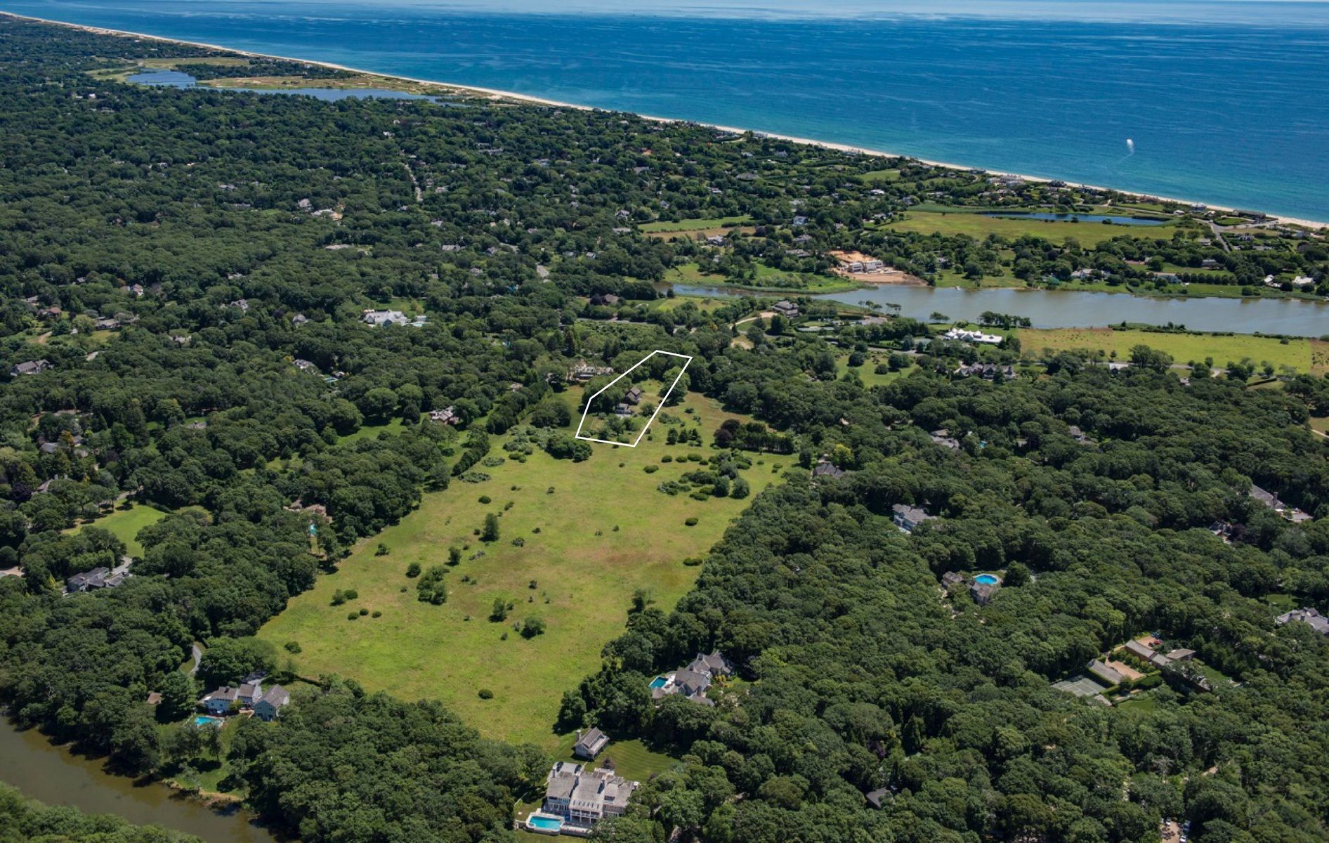10 B Briar Patch Road East Hampton, NY 11937 - Photo 1 of 5 a view of a forest with a lake