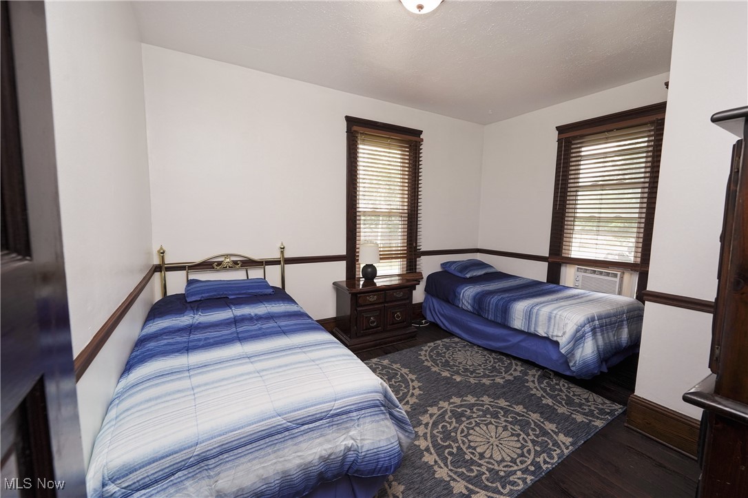 3542 Copley Road Akron, OH 44321 - Photo 25 of 47 Bedroom with wood-type flooring, multiple windows, a textured ceiling, and cooling unit