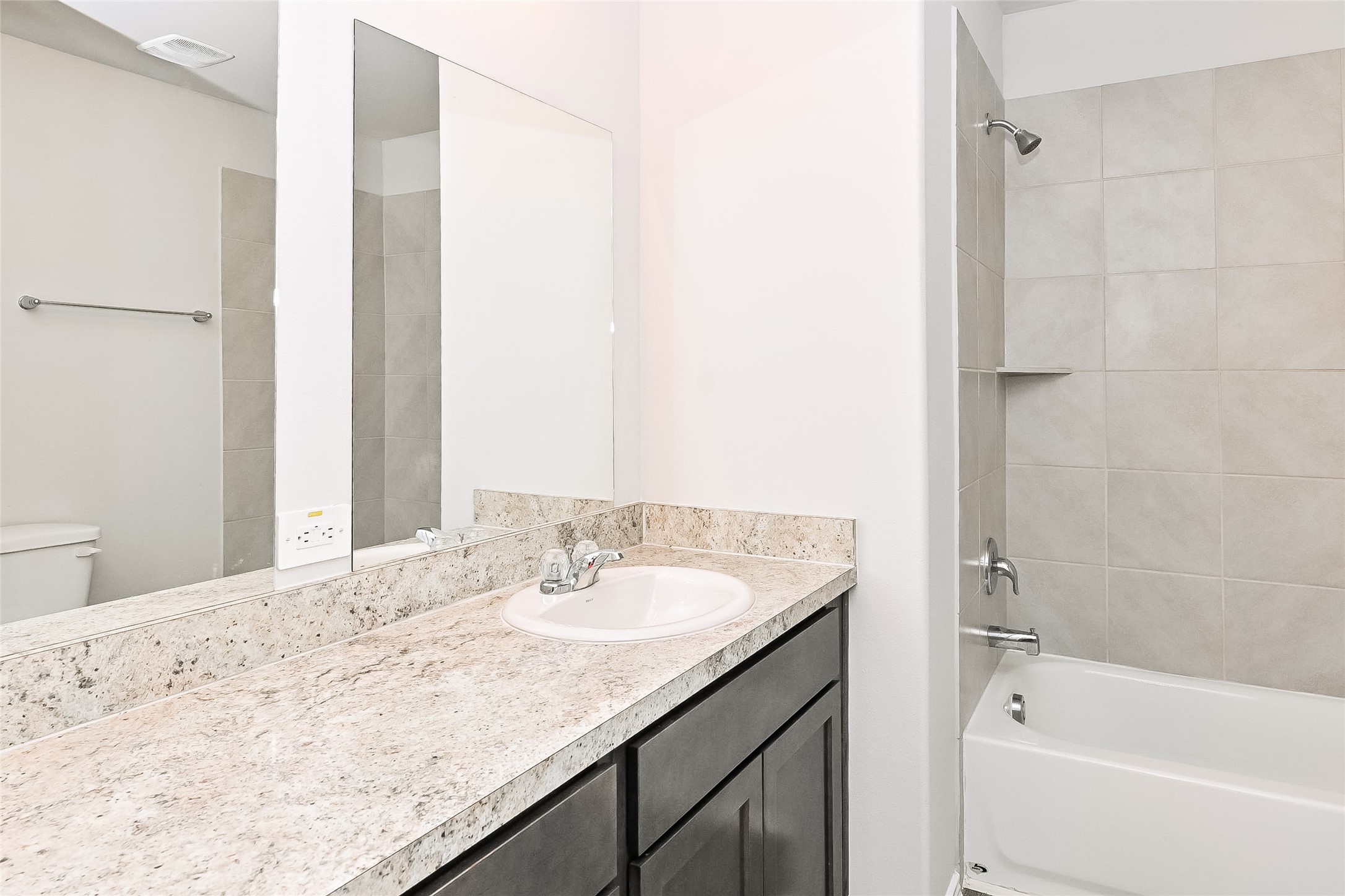 4911 Sweet Chestnut Lane Spring, TX 77373 - Photo 12 of 18 a bathroom with a granite countertop sink and a bathtub