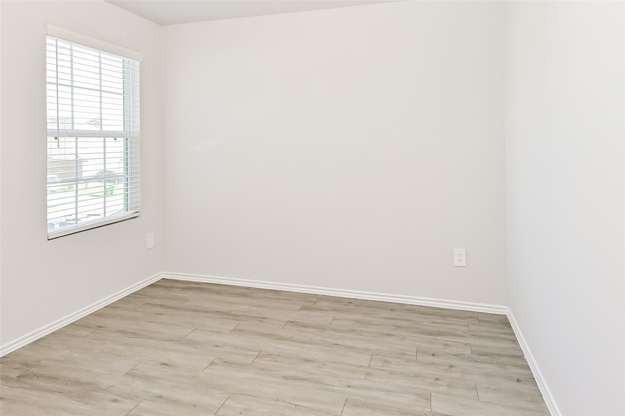 4911 Sweet Chestnut Lane Spring, TX 77373 - Photo 13 of 18 an empty room with wooden floor and windows