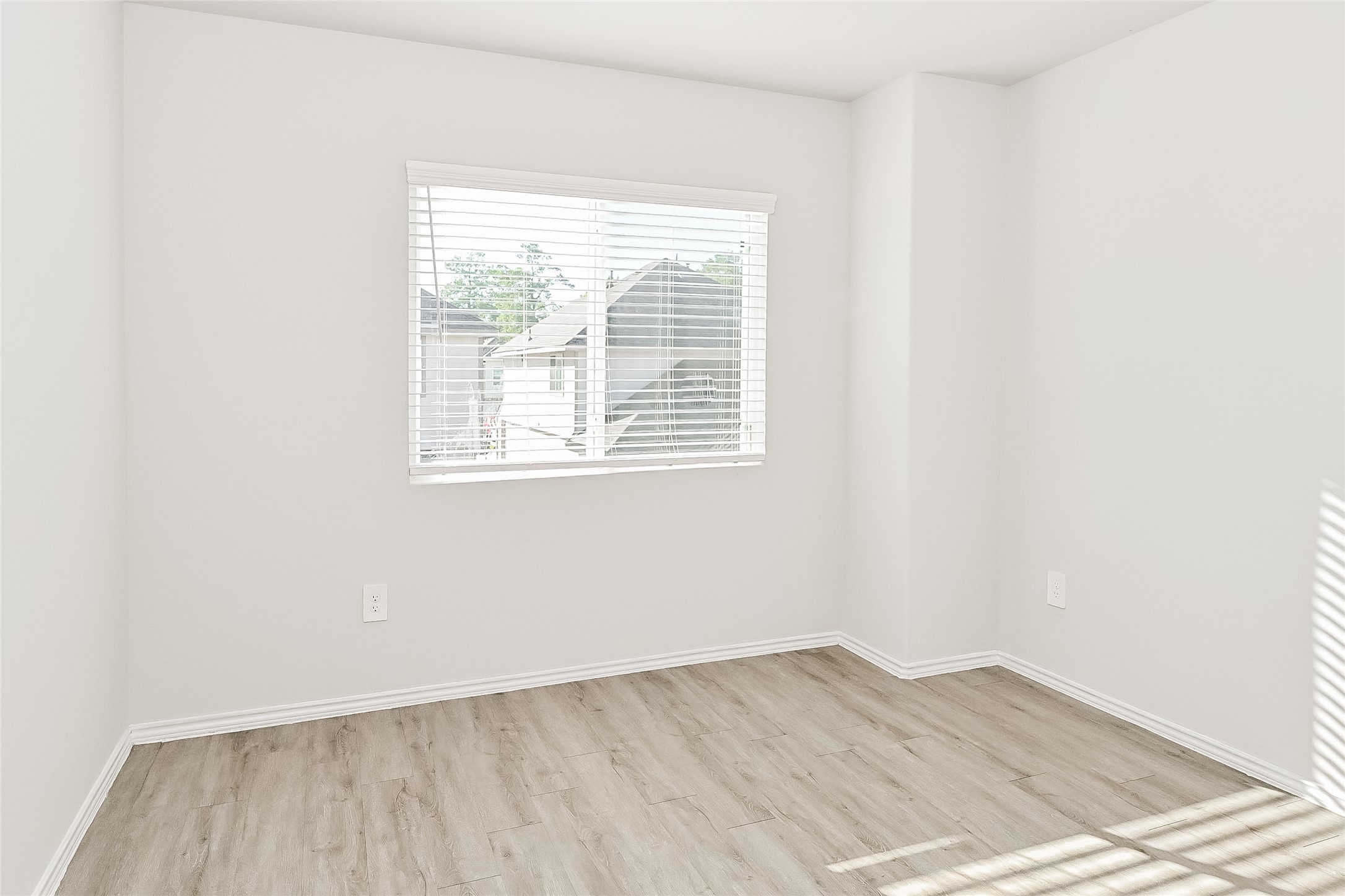 4911 Sweet Chestnut Lane Spring, TX 77373 - Photo 14 of 18 an empty room with wooden floor and windows