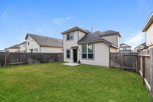 a view of a house with a yard and deck