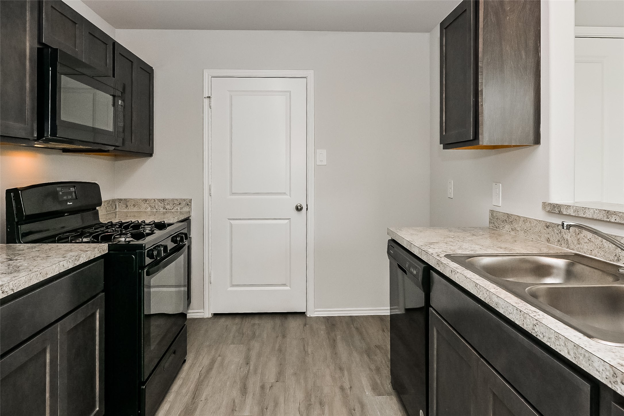 4911 Sweet Chestnut Lane Spring, TX 77373 - Photo 3 of 18 a kitchen with a sink and a stove top oven