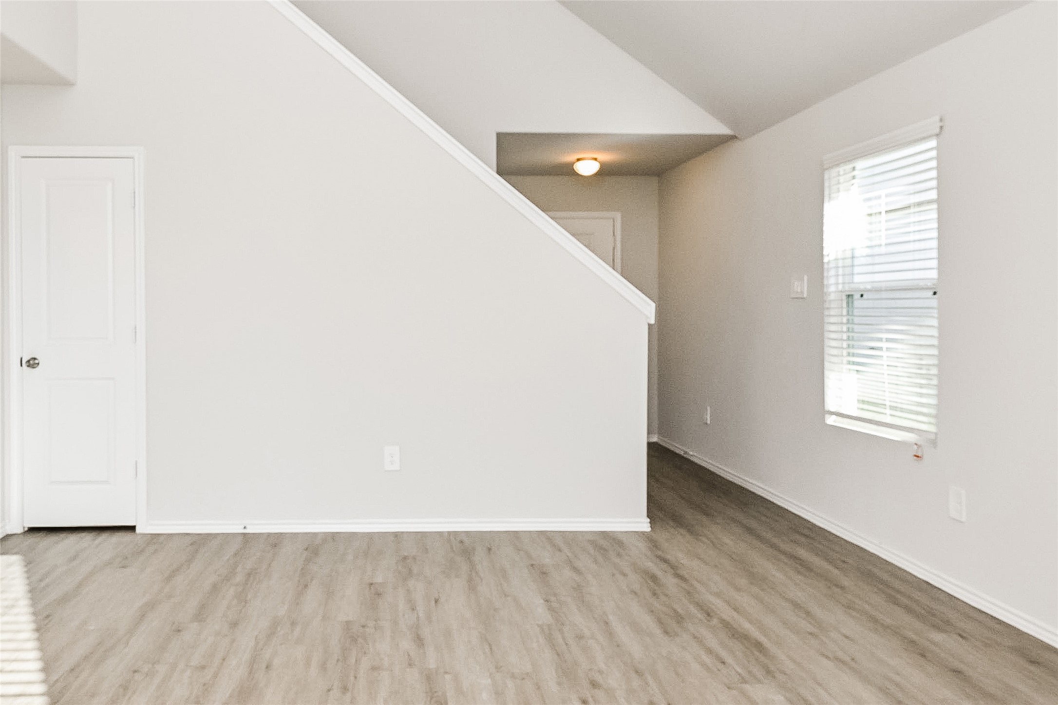 4911 Sweet Chestnut Lane Spring, TX 77373 - Photo 7 of 18 an empty room with wooden floor and windows