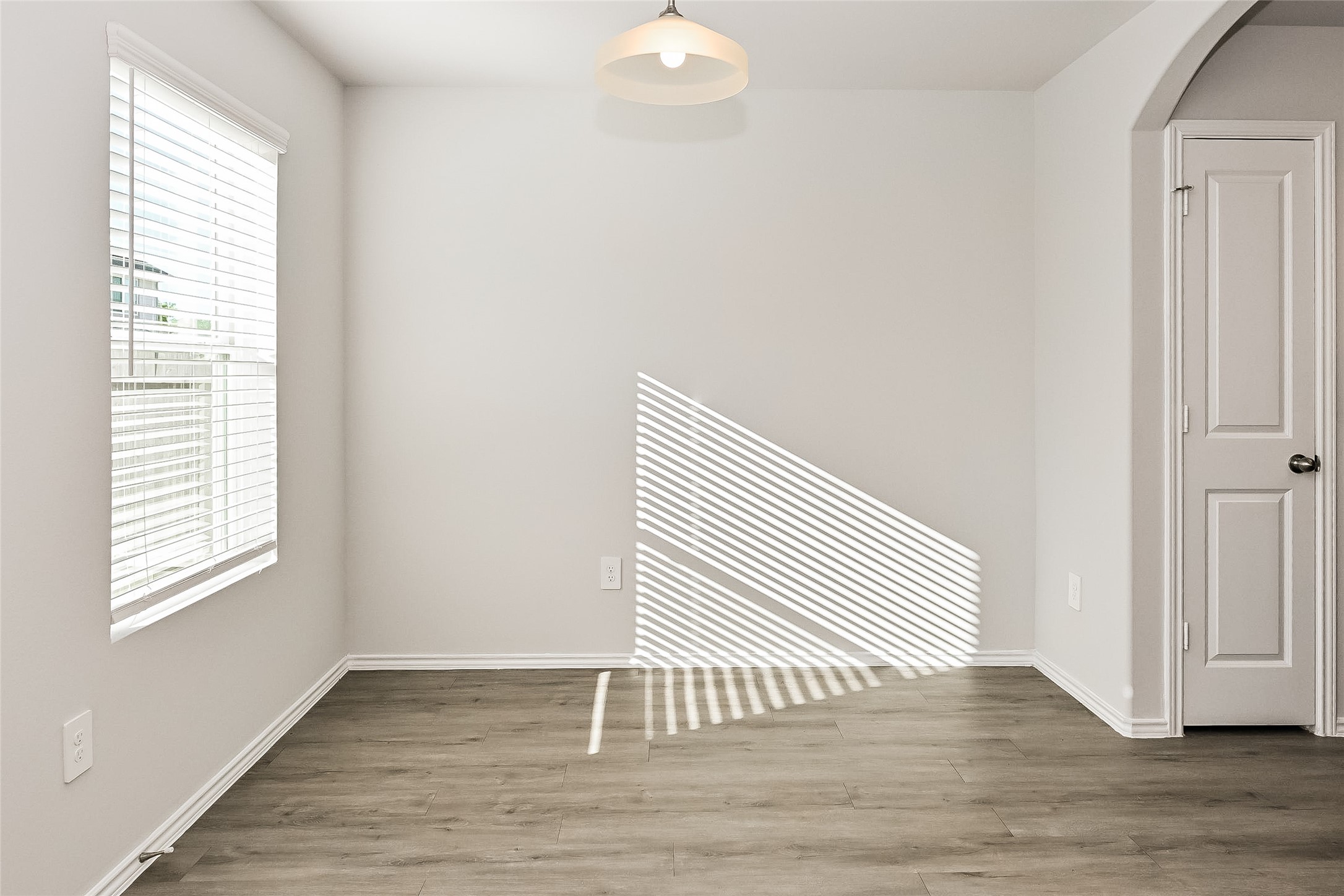 4911 Sweet Chestnut Lane Spring, TX 77373 - Photo 8 of 18 an empty room with wooden floor and windows