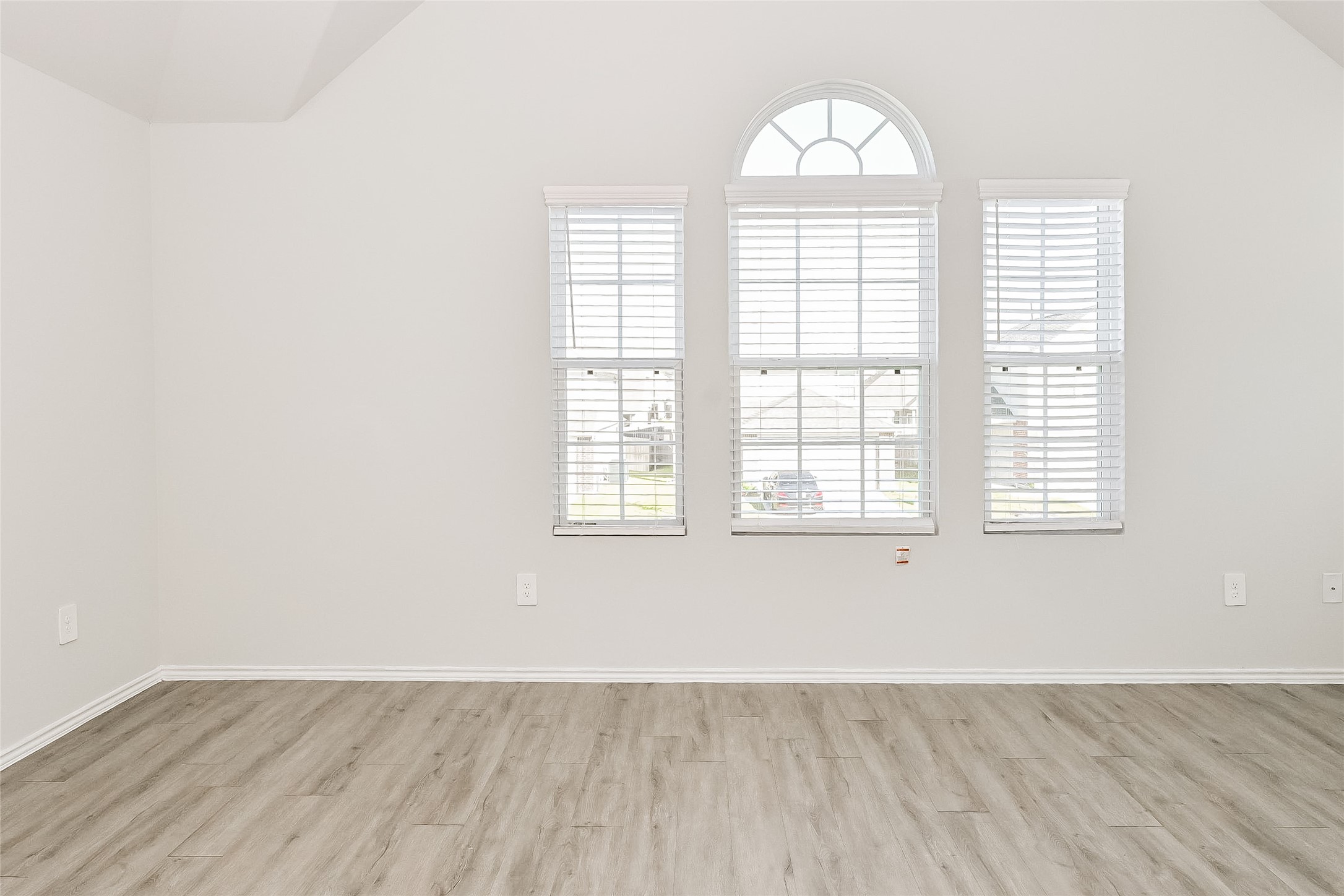 4911 Sweet Chestnut Lane Spring, TX 77373 - Photo 9 of 18 an empty room with wooden floor and windows