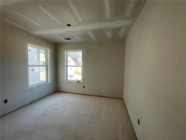 an empty room with a empty space and windows