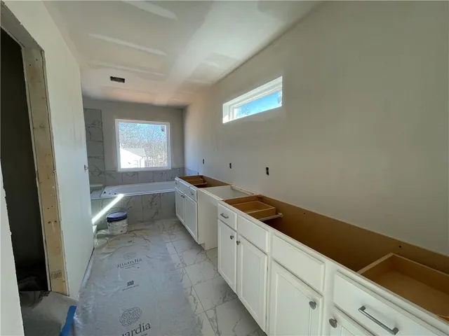 a bathroom with a bathtub and window