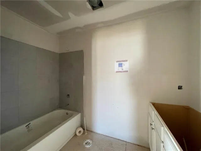 a bathroom with a tub sink and vanity