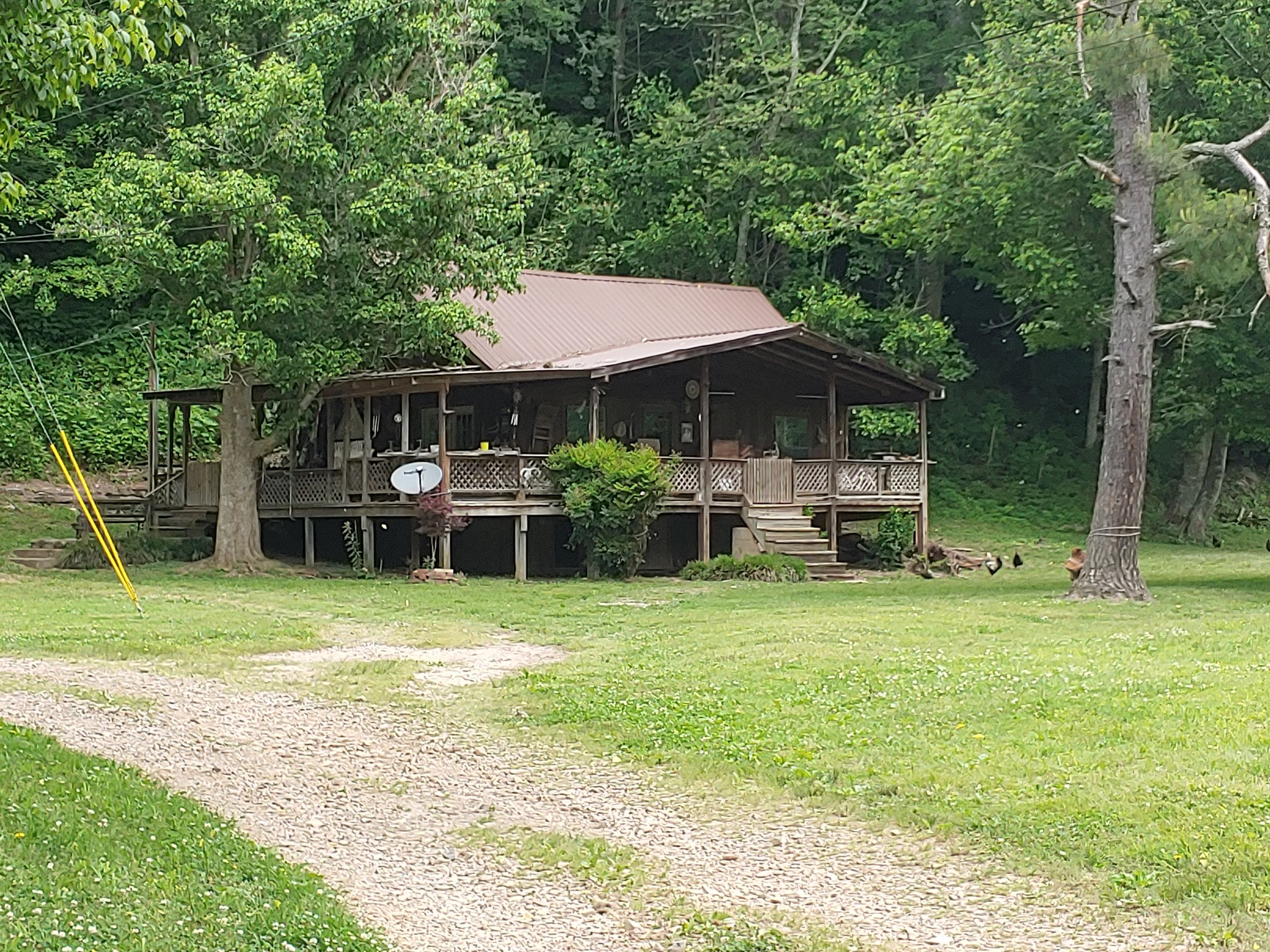 176 Wills Road Hurricane Mills, TN 37078 - Photo 2 of 32 a backyard of a house with yard table and chairs