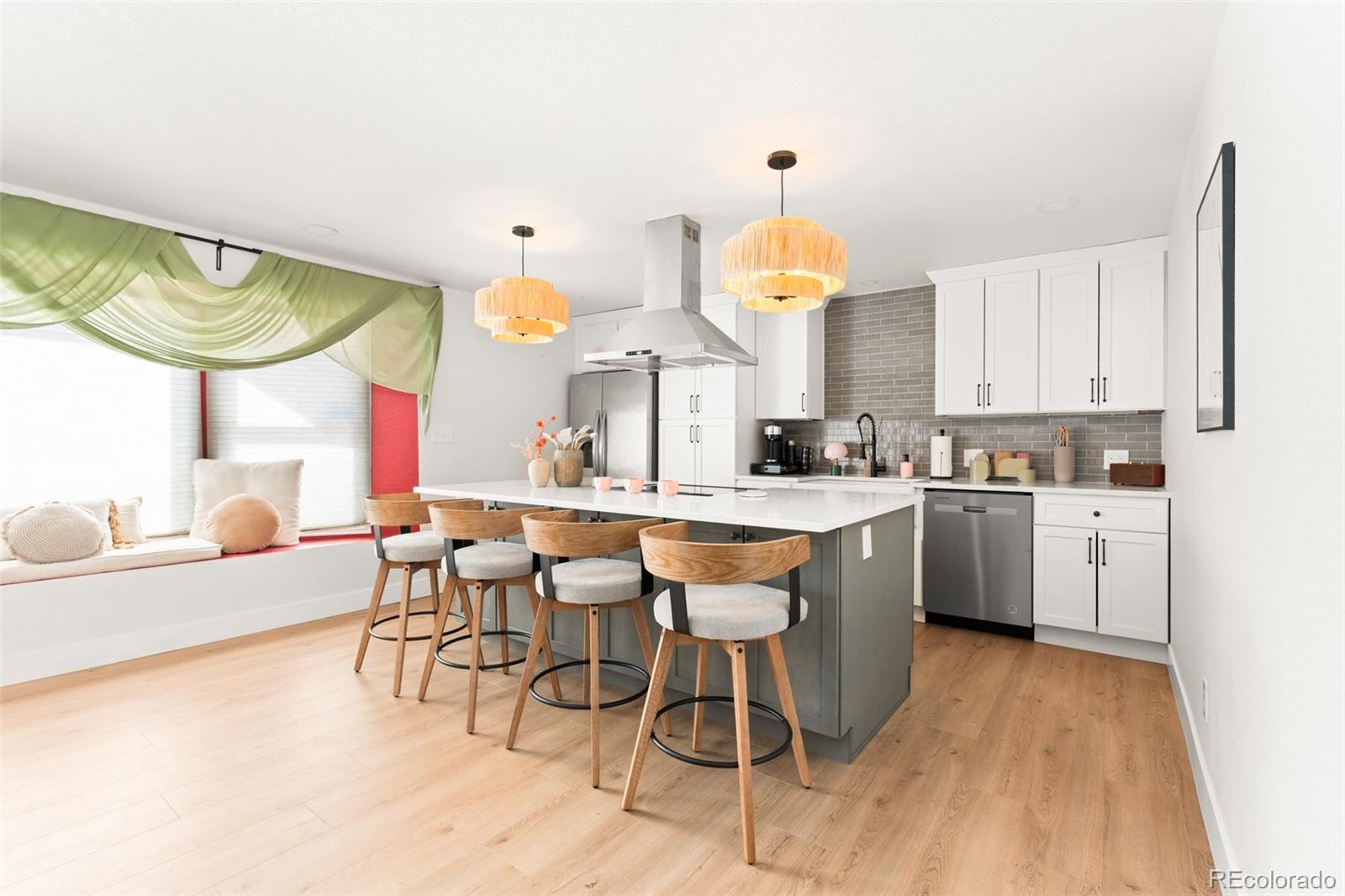 a kitchen with stainless steel appliances granite countertop a sink a stove a refrigerator and island with wooden floor