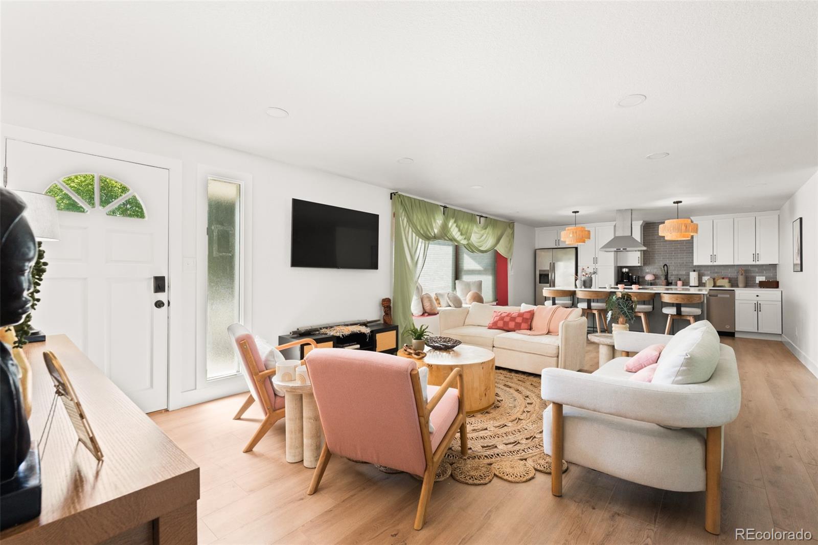 6115 Chase Street Arvada, CO 80003 - Photo 11 of 45 a living room with fireplace furniture and a flat screen tv