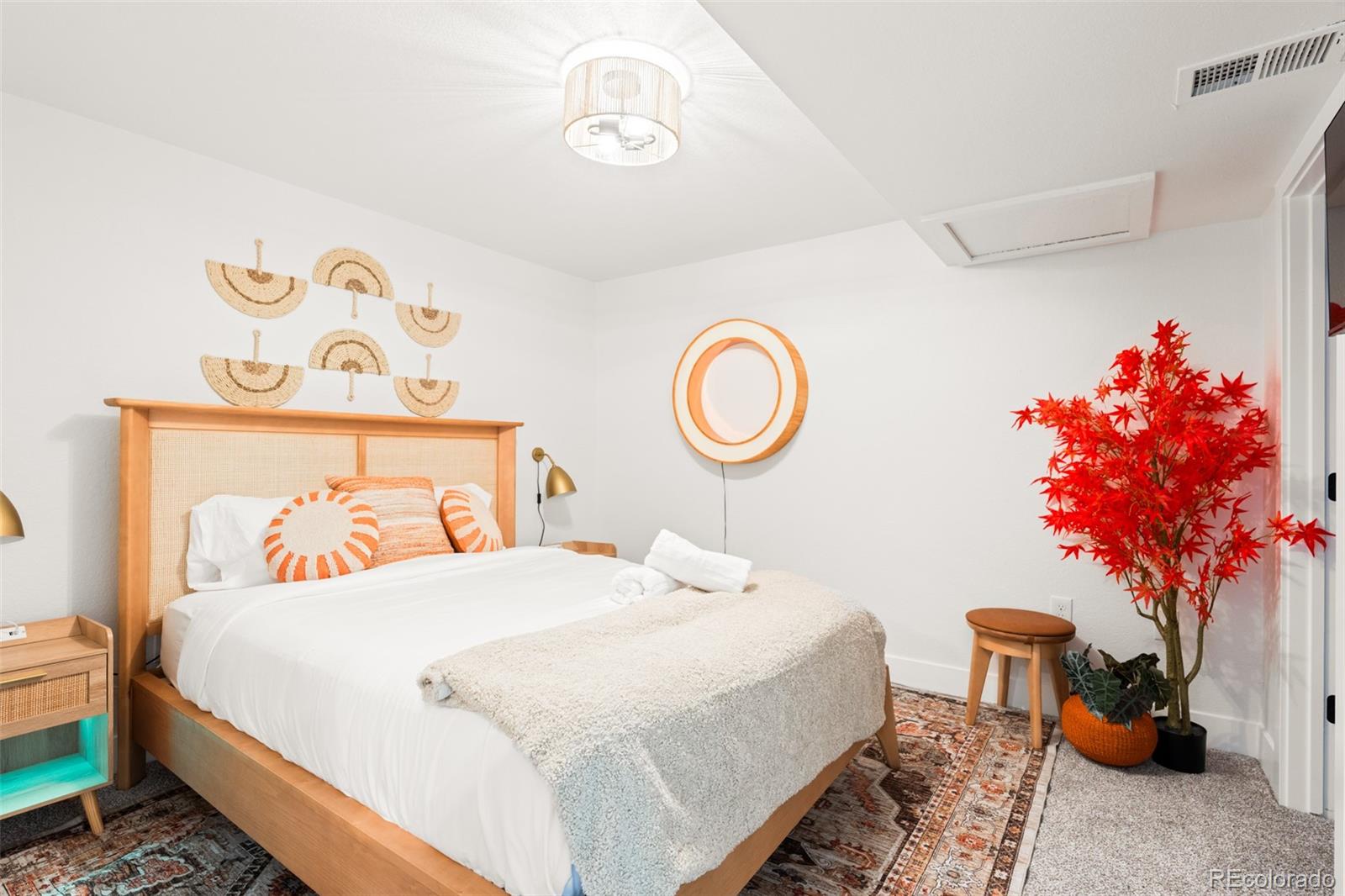 6115 Chase Street Arvada, CO 80003 - Photo 19 of 45 a bedroom with a bed and a chandelier