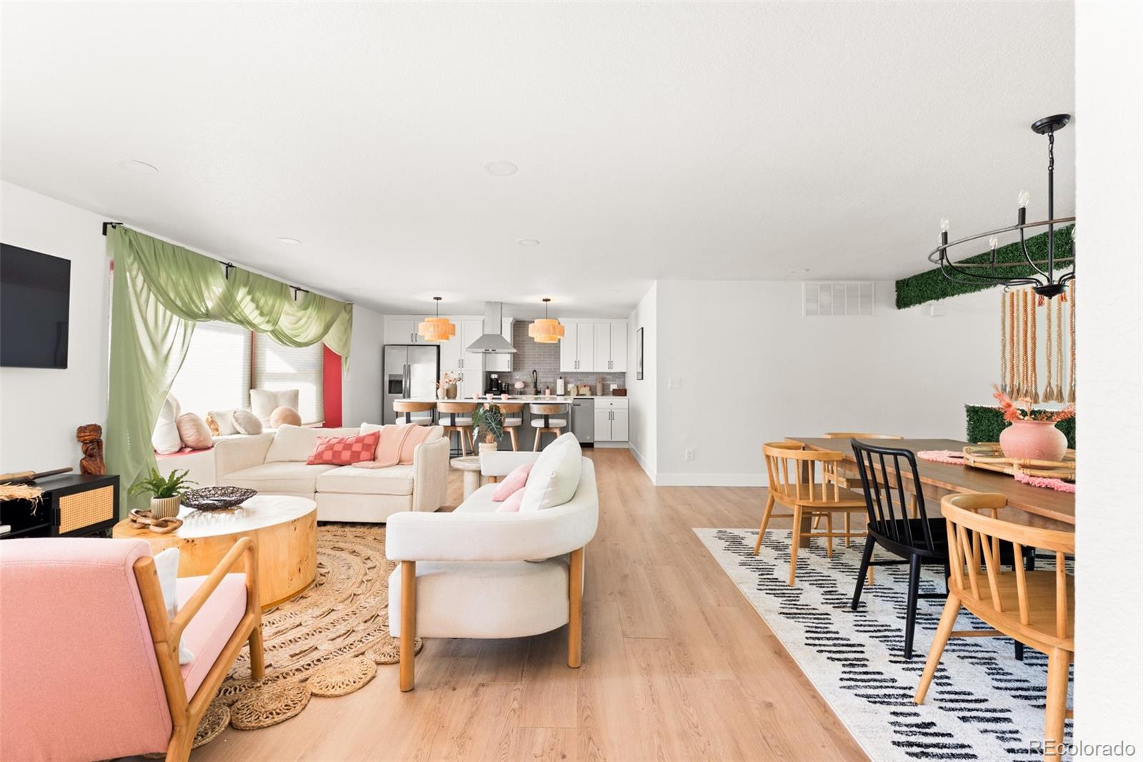 6115 Chase Street Arvada, CO 80003 - Photo 2 of 45 a living room with furniture a fireplace and a table