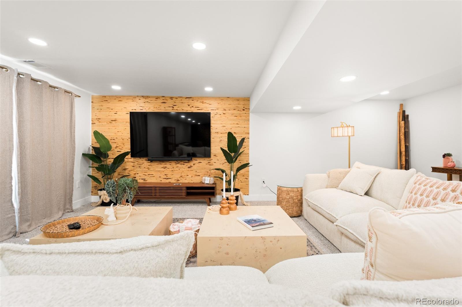 6115 Chase Street Arvada, CO 80003 - Photo 24 of 45 a living room with furniture and a flat screen tv