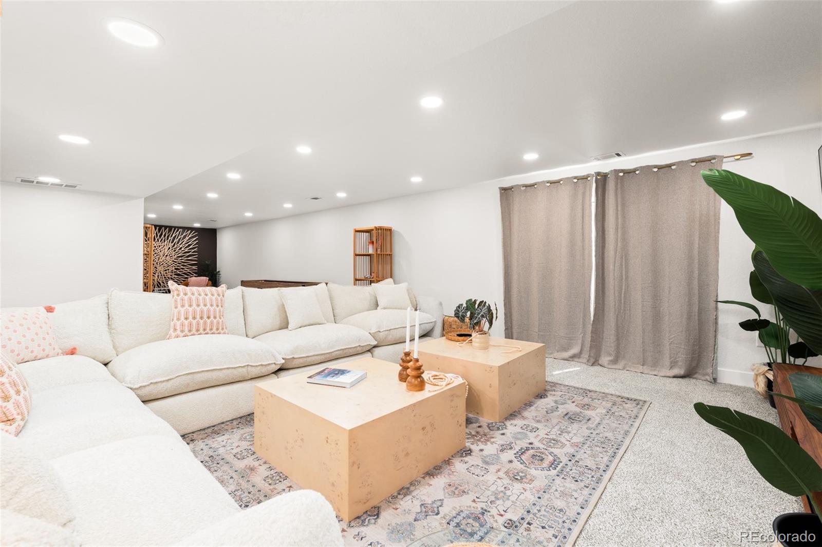 6115 Chase Street Arvada, CO 80003 - Photo 26 of 45 a living room with furniture and a large window