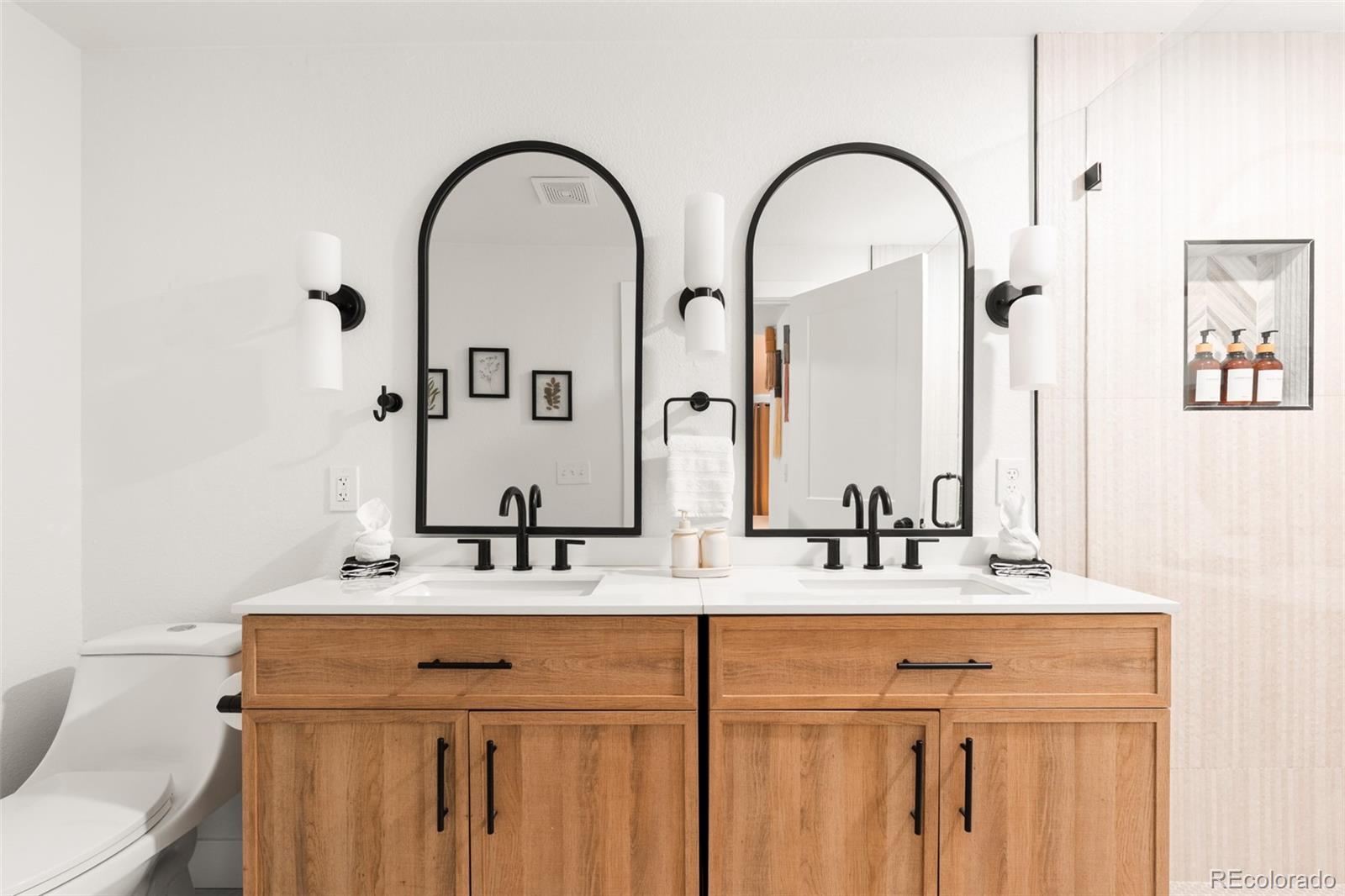 6115 Chase Street Arvada, CO 80003 - Photo 33 of 45 a bathroom with a double vanity sink and a mirror