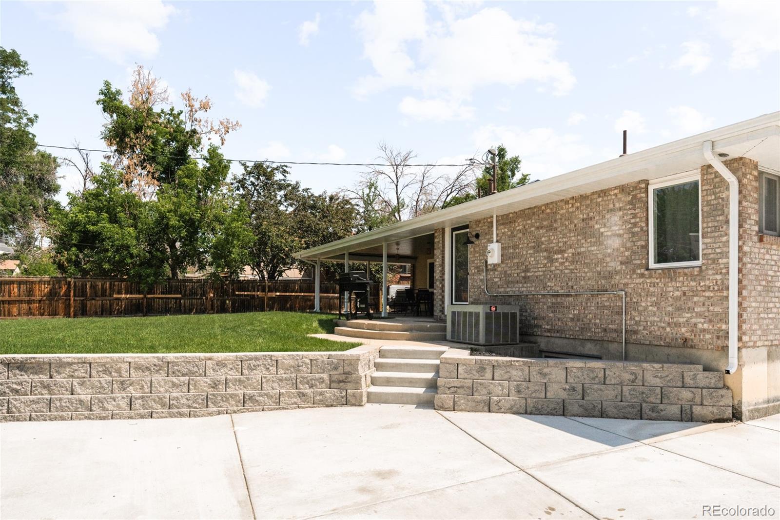 6115 Chase Street Arvada, CO 80003 - Photo 37 of 45 a view of a house with a yard