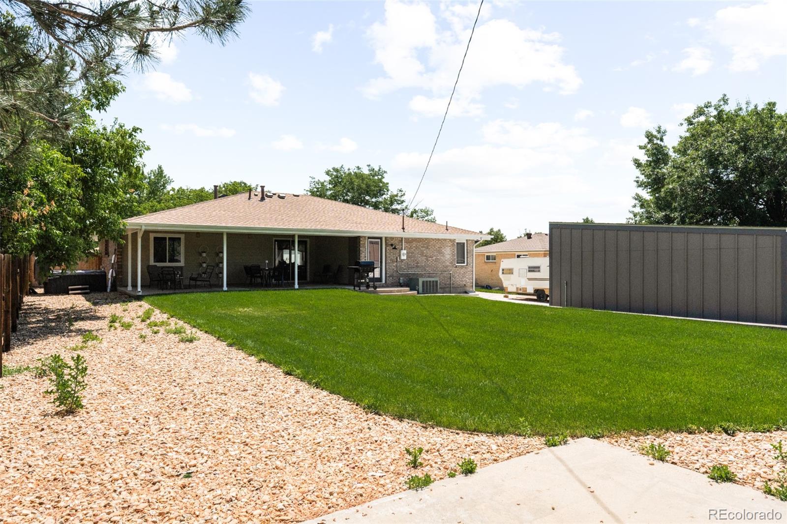 6115 Chase Street Arvada, CO 80003 - Photo 38 of 45 a front view of a house with a yard
