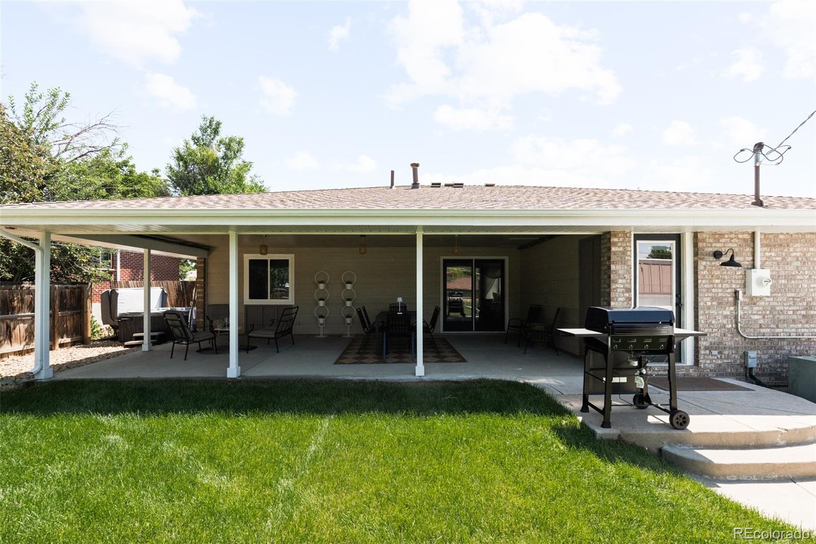 6115 Chase Street Arvada, CO 80003 - Photo 39 of 45 a front view of house with a garden and patio