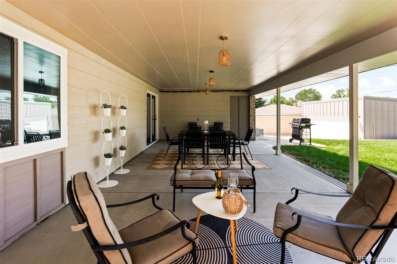 6115 Chase Street Arvada, CO 80003 - Photo 42 of 45 a view of a dining room with furniture wooden floor and a chandelier