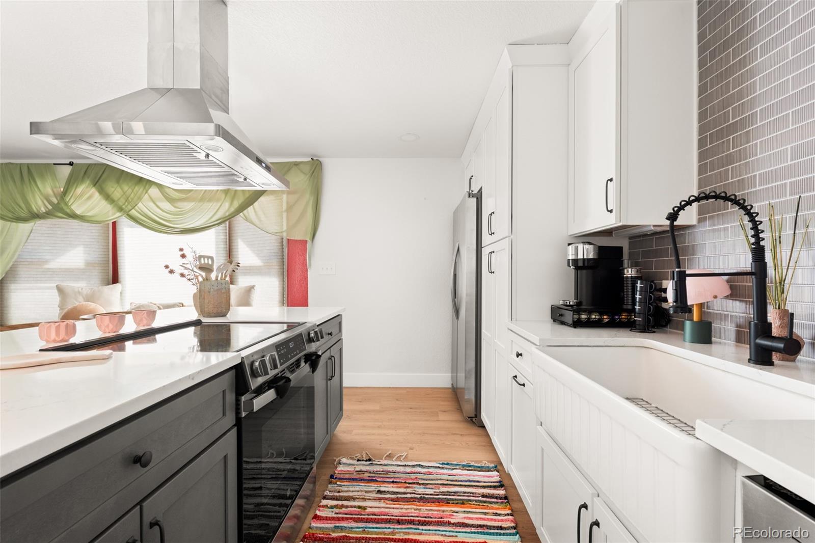 6115 Chase Street Arvada, CO 80003 - Photo 6 of 45 a kitchen with a sink and a stove