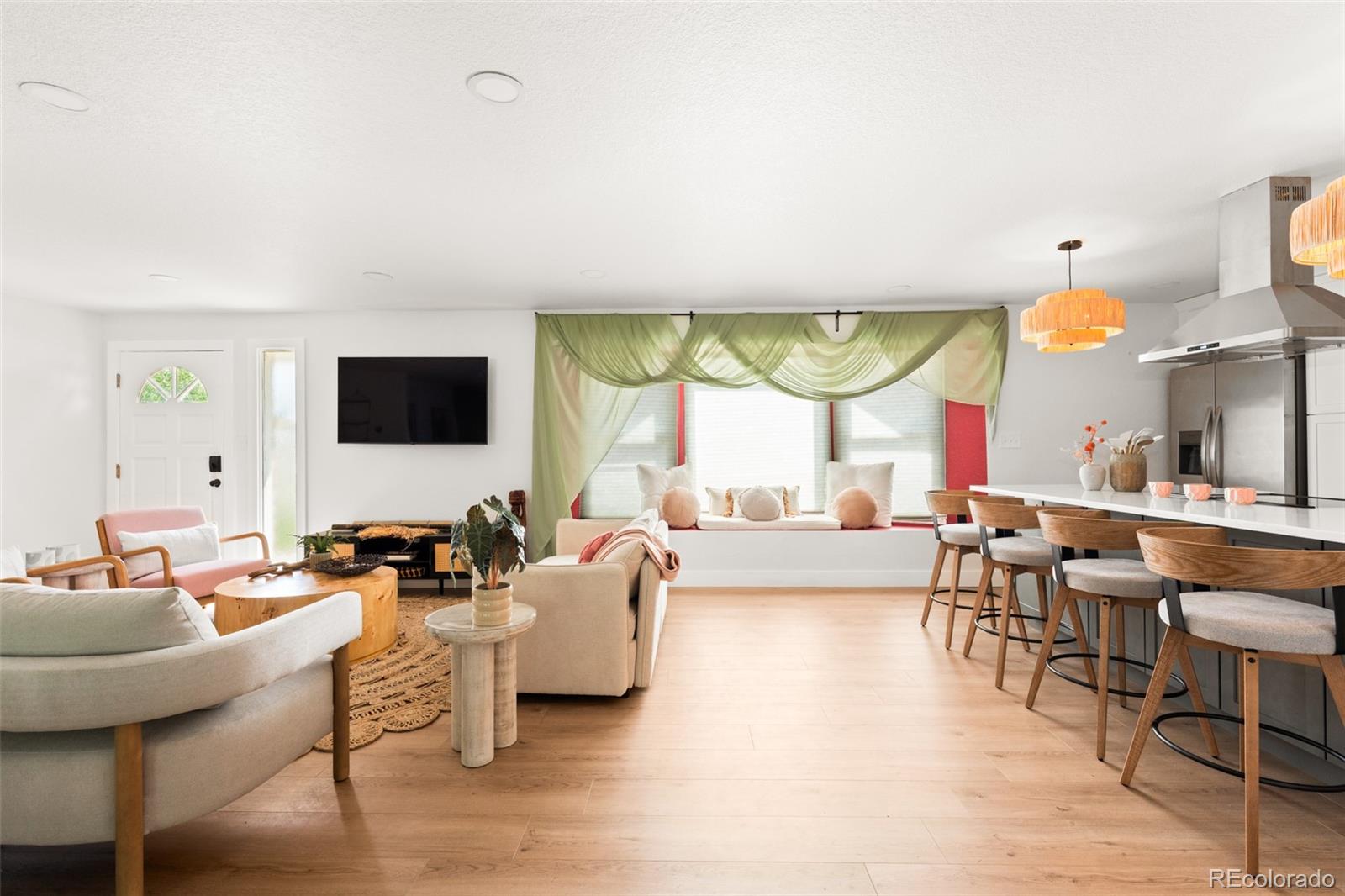 6115 Chase Street Arvada, CO 80003 - Photo 8 of 45 a living room with fireplace furniture and a flat screen tv