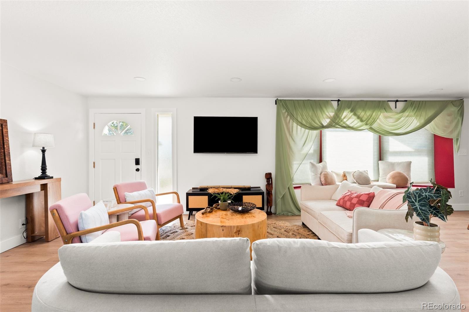 6115 Chase Street Arvada, CO 80003 - Photo 10 of 45 a living room with furniture tv and a large window