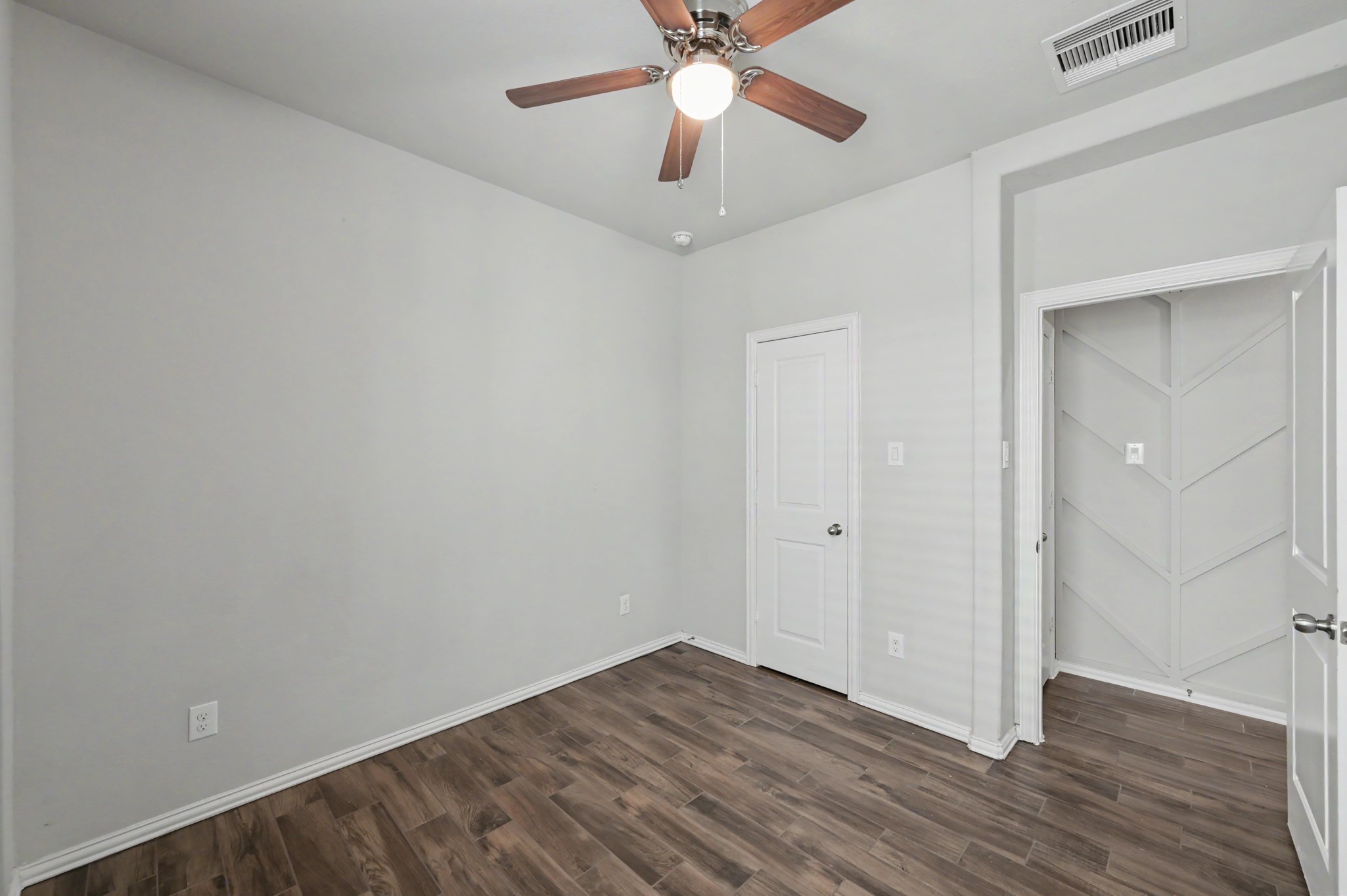 29836 Woodsons Edge Way Spring, TX 77386 - Photo 20 of 38 Alternate view of the secondary bedroom and geometric wood accent wall in the hallway.