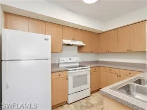a white refrigerator freezer sitting inside of a kitchen