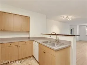 a kitchen with a sink cabinets and appliances