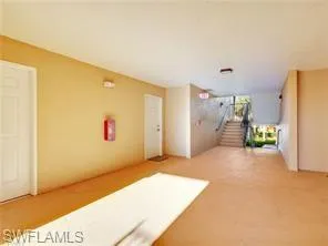 a view of livingroom with painted wall and a large window
