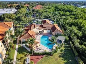 an aerial view of a house with a yard and outdoor seating